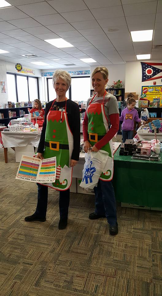 two women with elf aprons on